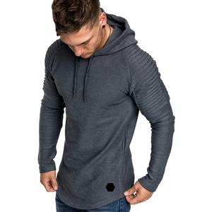 Detail of men's slim fit hoodie featuring horizontal pleated raglan sleeves and textured fabric