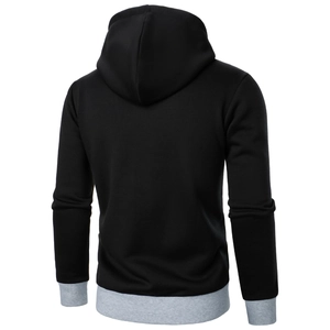 Detail of black hoodie with grey ribbed cuffs and hem showing knit fabric texture