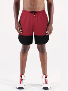 Detail of red and black men's running shorts featuring elastic drawstring waist and mesh fabric
