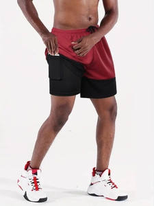 Detail of red 2-in-1 running shorts featuring a black phone pocket on inner compression liner