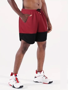 Detailed close-up of red and black marathon shorts featuring breathable mesh and drawstring