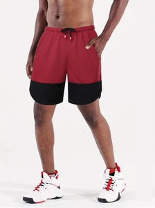 Detail of red and black marathon running shorts with elastic drawstring waistband and side slits