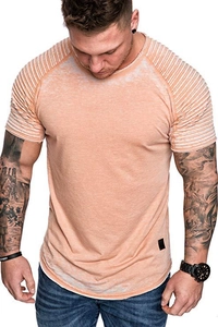 Detail of vintage orange men's T-shirt showing pleated shoulder and raglan sleeve design