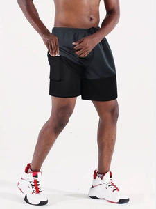 Detail of men's double-layer running shorts with built-in phone pocket and mesh fabric