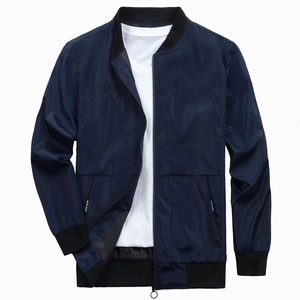 Detail of navy bomber jacket featuring rib-knit collar and cursive chest embroidery