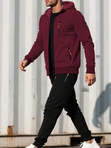 Detail of burgundy textured hoodie with orange zipper puller and black joggers