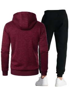 Detail of burgundy hooded sweatshirt and black slim joggers with ribbed cuffs and texture