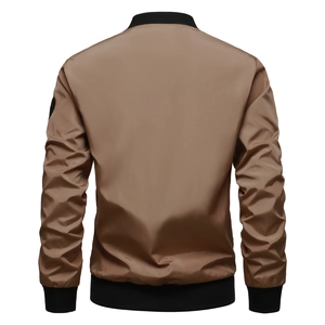 Back view of men's bomber jacket with ribbed cuffs and badge detail on the sleeve