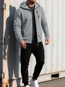 Detail of grey knitted hoodie with neon green zipper accents and textured fabric