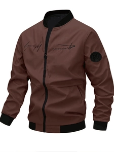 Close-up detail of embroidery and round badge on brown casual bomber jacket