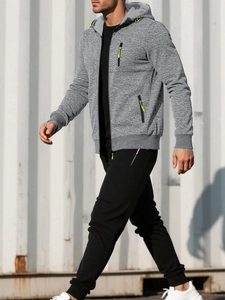 Detail of grey men's hoodie with neon green zipper puller and drawstring on a walking model