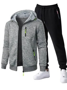Detail of grey men hoodie with neon green zippers and black athletic joggers