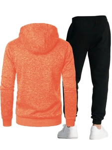 Detail view of orange textured hoodie and black tapered joggers athletic suit