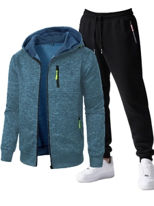 Detail view of blue textured knit sports hoodie with green zippers and black jogger pants