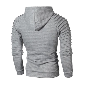 Detail of grey men's hoodie featuring quilted square texture and pleated sleeve design