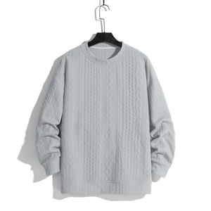 Men's light grey crewneck cable knit sweater with textured patterns and ribbed cuffs