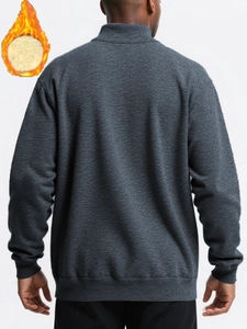 Macro detail of men's thermal sweatshirt showing dark grey fabric and fleece lining warmth