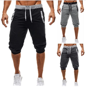 Detailed view of elastic drawstring waist and side pockets on men's athletic shorts