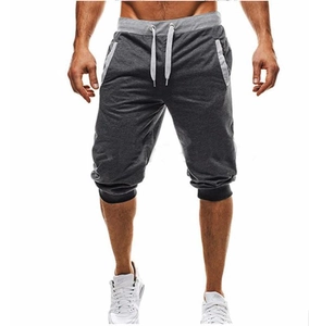 Detail of dark grey joggers with light grey contrast panels and white drawstrings