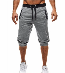 Detail of grey slim fit jogger shorts featuring black elastic waistband and drawstring