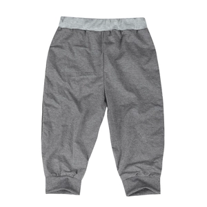 Close-up of grey knit joggers featuring a light grey ribbed elastic waistband and cuffs