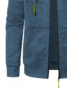 Détail du sweat à capuche en tricot bleu marine avec poche à zip vert fluo