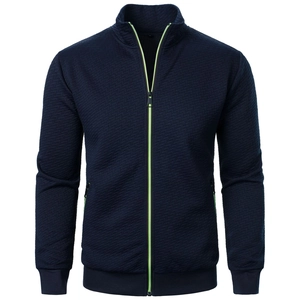Detail of navy zip-up jacket featuring contrast neon green zipper and diamond texture