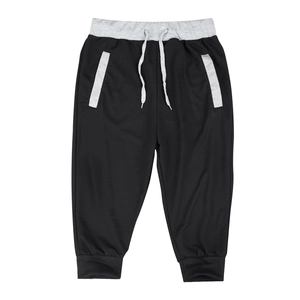 Detail of elastic light grey waistband with white adjustable drawstrings on black joggers
