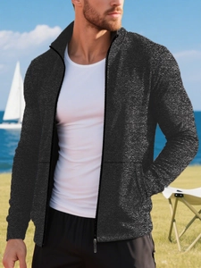 Close-up of black men's knit cardigan with shiny texture and metallic zipper detail