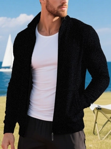 Detailed shot of men's black zip-up knit sweater with standing collar and metal zipper