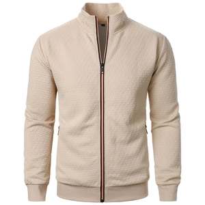 Detail of men's beige waffle knit jacket showing zip closure and ribbed texture