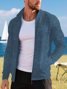 Detail of dark blue knit sweater with snowflake texture and full zipper stand collar