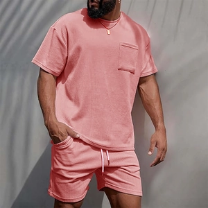 Detail of pink corduroy men's short set showing ribbed knit texture and chest pocket