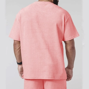 Detail of pink corduroy men's t-shirt and shorts set with vertical ribbed texture