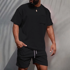Detail of black corduroy men's t-shirt and shorts set with textured fabric and chest pocket