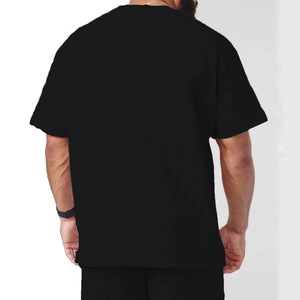 Rear view of black corduroy men's t-shirt and shorts set showing fine ribbed fabric texture
