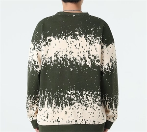 Detail view of the digital pixel block pattern on the back of this green knit sweater