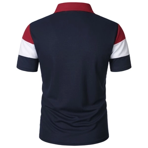 Detailed view of tricolor striped ribbed cuffs on a navy blue cotton polo shirt