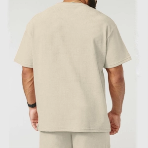 Detailed back view of corduroy texture on men's beige crewneck t-shirt and shorts set