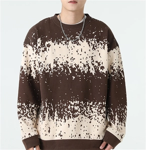 Macro detail of men striped knit sweater featuring pixelated brown and white patterns