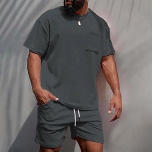 Detail of dark grey corduroy textured shorts set with chest pocket and white drawstrings