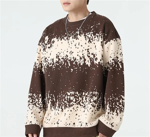 Detail of men striped sweater with brown and cream pixel patterns and ribbed neckline