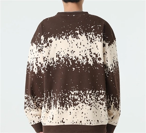 Detail of pixel art gradient stripes on brown and beige oversized knitted sweater