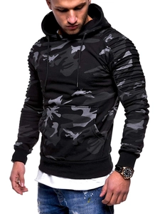Detail of men's camo hoodie featuring pleated raglan sleeves and layered white hem design