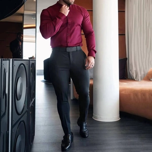 Slim fit men's burgundy long sleeve button shirt with black dress pants and leather belt