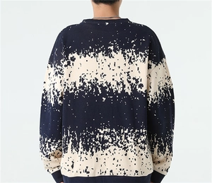 Detailed back view of men's striped knit sweater with pixelated pattern and ribbed cuffs