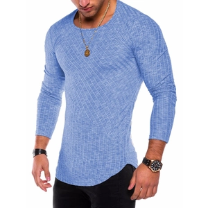 Detail of blue long-sleeve knit T-shirt featuring curved hem and textured patchwork fabric