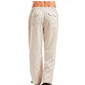 Detail view of beige linen pants featuring elastic waist and rear buttoned flap pockets