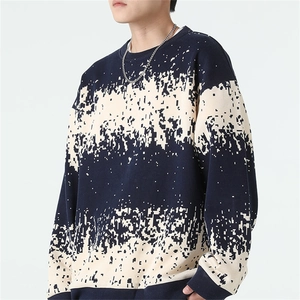 Detailed close-up of dark blue knit sweater with white pixelated digital glitch print