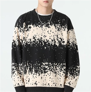 Macro detail of men's crewneck sweater featuring pixelated noise pattern and ribbed texture